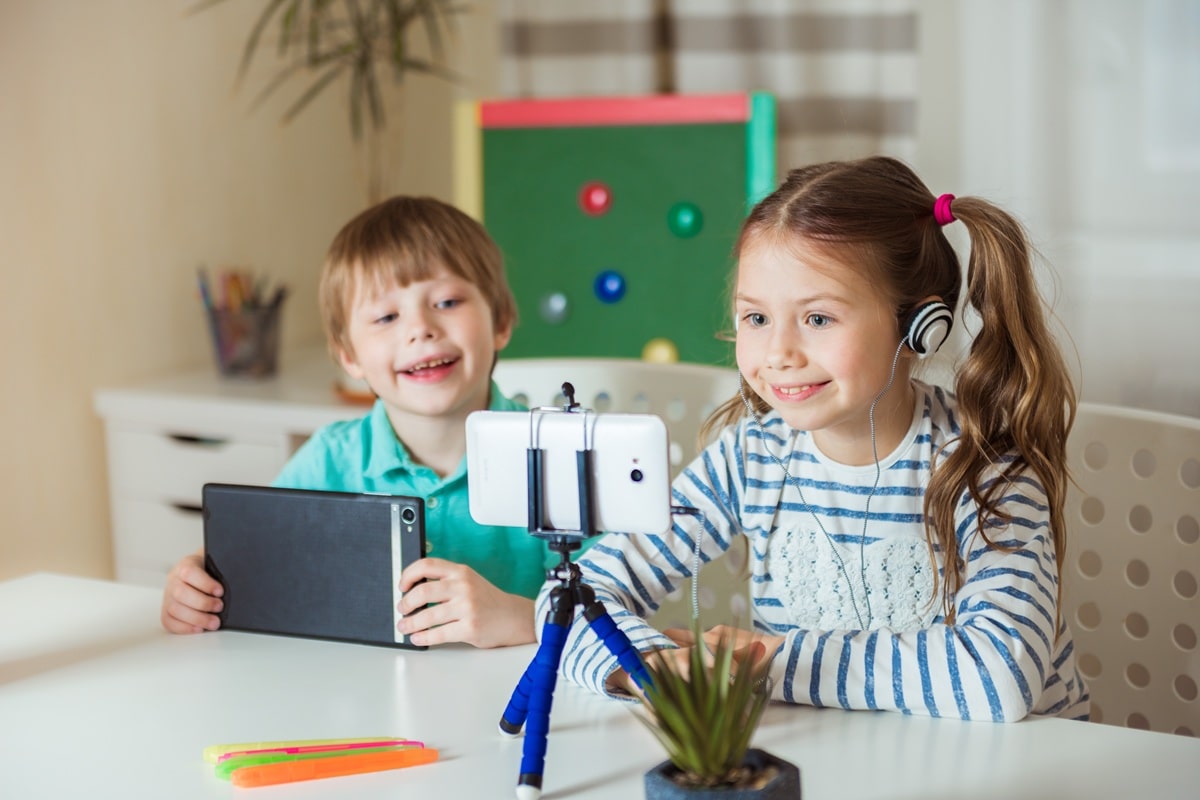 children-study-at-home-distance-learning-online-w-2025-06-08-17-52-08-utc-min A young girl with her brother in the background taking part in an online lesson with ATTC Education.