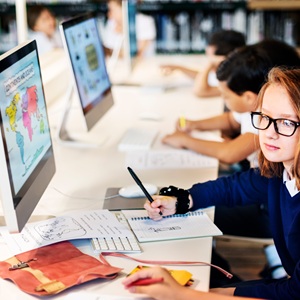 Young girl working on a computer at school