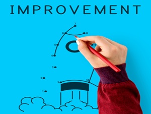 A hand drawing a rocket with the words Improvement at the top of the image.