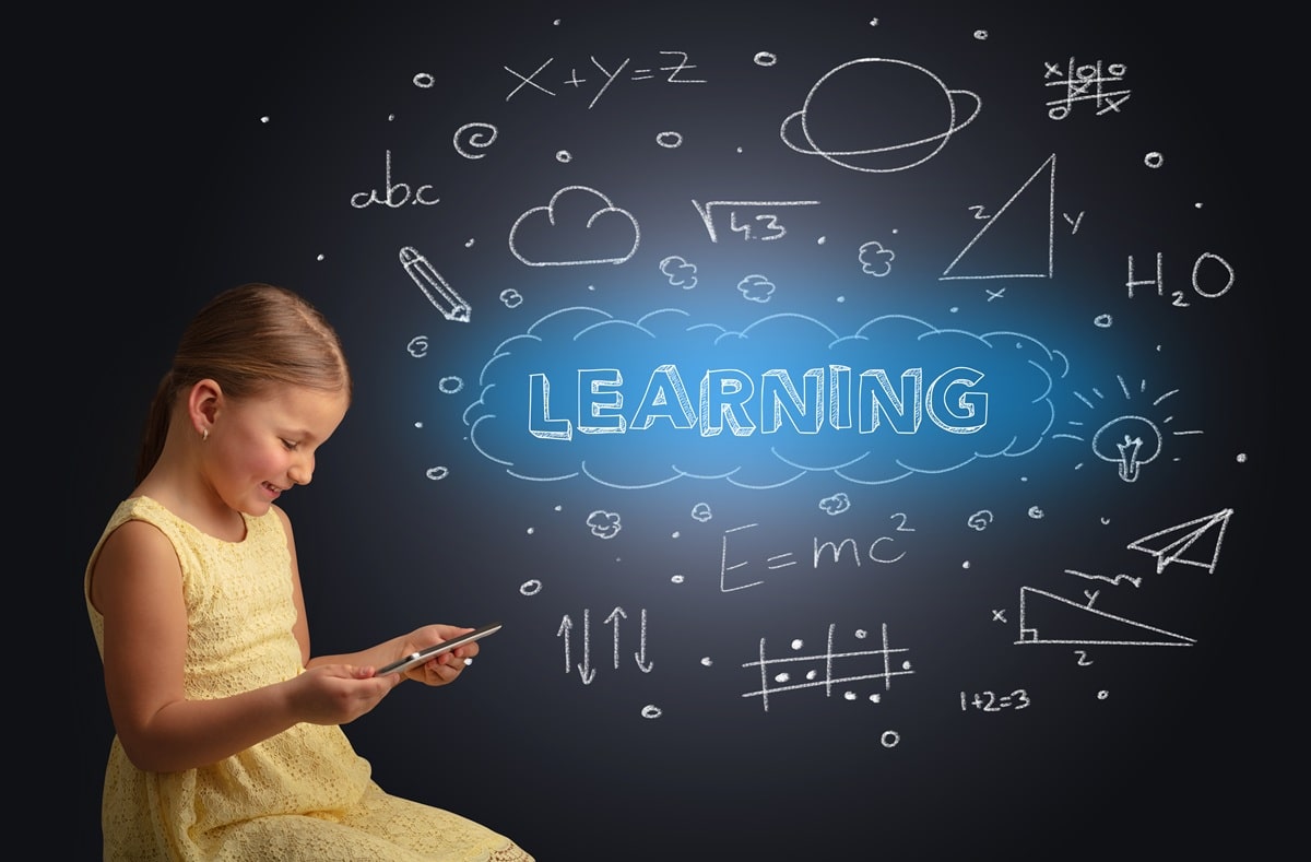 The online learning concept with a little girl looking at an ipad with the words and shapes on a black background.