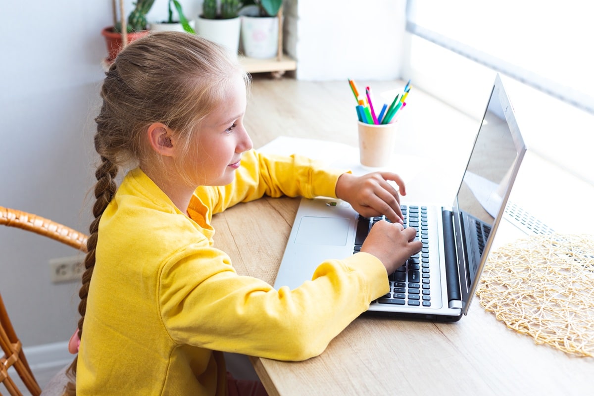 Young girl on a lap top computer