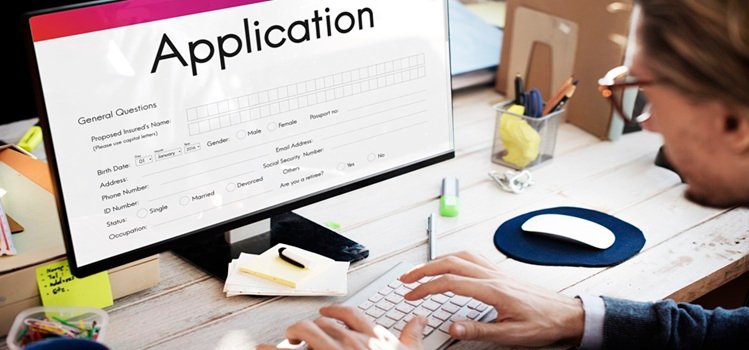 A man filling out an application form online.