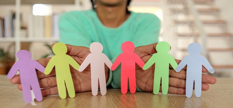 Colorful Diversity Icon Paper Stand On Hands, representing safeguarding.